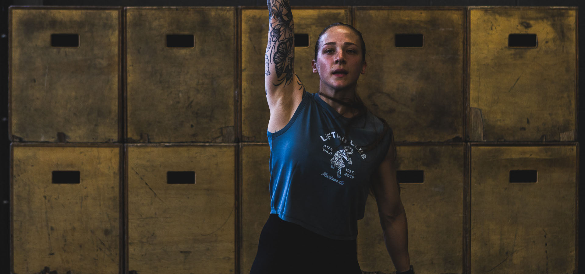 Athlete lifts kettlebell. 