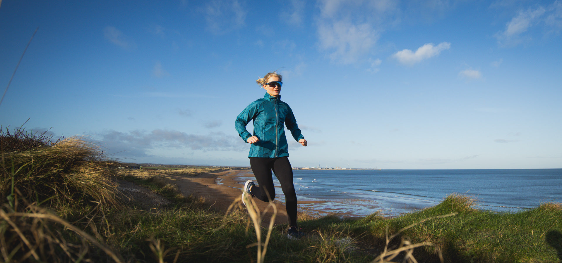 Athlete runs through dunes